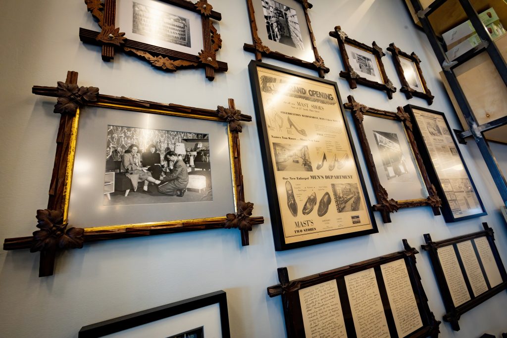 Many historic photos and press clippings highlighting the store's rich history are displayed near the entrance of the Mast Shoe Store showroom in Ann Arbor.