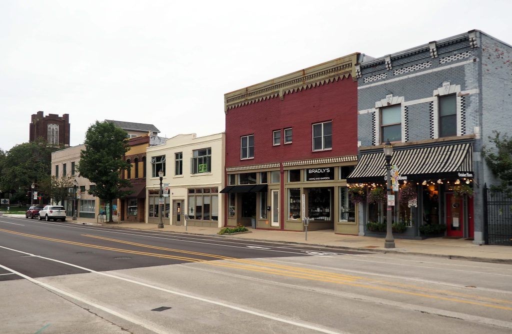 Lansing, MI / USA - September, 29, 2019: Old Town Lansing, Cesar Chavez Ave near the fish ladder. Two-storied buildings of different colors. Shop windows. No people.